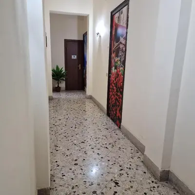 a hallway with a tile floor and a door at Arco di Trionfo Palermo Bed & Breakfast in Palermo