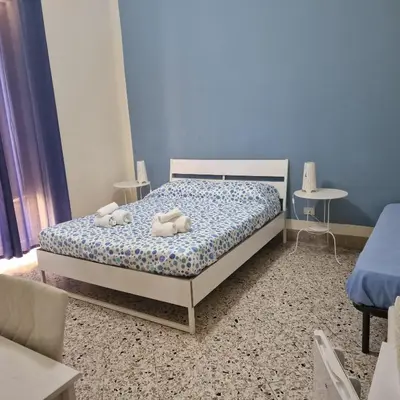 a bedroom with a bed with two stuffed animals on it at Arco di Trionfo Palermo Bed & Breakfast in Palermo