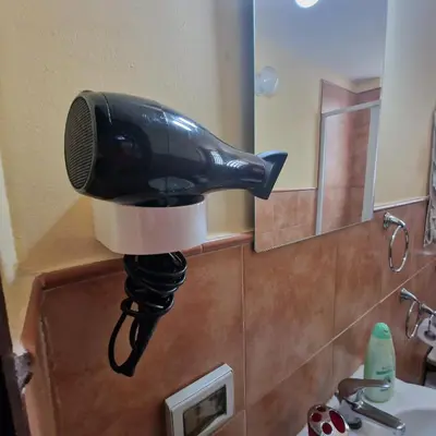a black fish head hair dryer on the wall of a bathroom at Arco di Trionfo Palermo Bed & Breakfast in Palermo