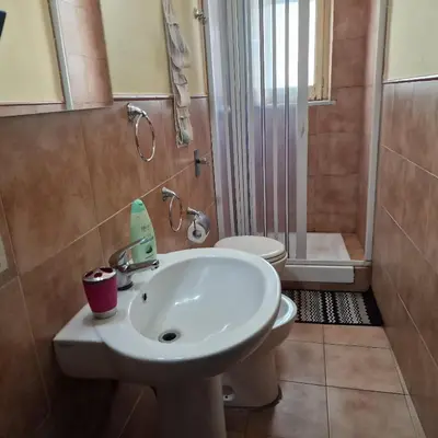 a bathroom with a sink and a toilet and a shower at Arco di Trionfo Palermo Bed & Breakfast in Palermo