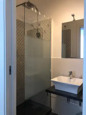 a bathroom with a sink and a glass shower at Teatro Massimo Cool Home in Palermo