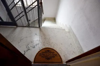 a staircase with a wooden sign on the floor at Teatro Massimo Cool Home in Palermo