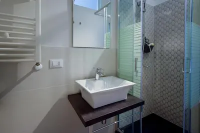 a bathroom with a sink and a shower at Teatro Massimo Cool Home in Palermo