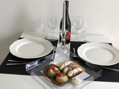 a table with two plates and a plate of food at Teatro Massimo Cool Home in Palermo