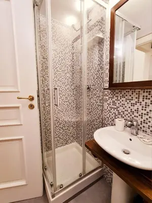 a bathroom with a shower and a sink at Natoli Apartments in Palermo