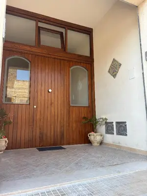 a patio with chairs and a table and a view of a mountain at Casa Vacanze Monacò in San Vito lo Capo