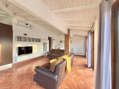 a living room with a couch and a tv at Villa Cocus in Altavilla Milicia
