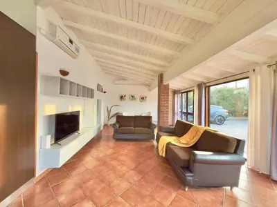 a living room with two couches and a tv at Villa Cocus in Altavilla Milicia