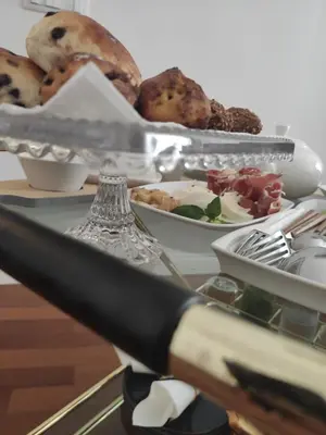 a table with a plate of food and a knife at Il Rosone Luxury B&B in Palermo