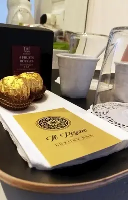 a table with a napkin and a box of food at Il Rosone Luxury B&B in Palermo