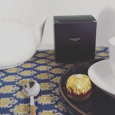 a table with a cupcake and a box and a spoon at Il Rosone Luxury B&B in Palermo