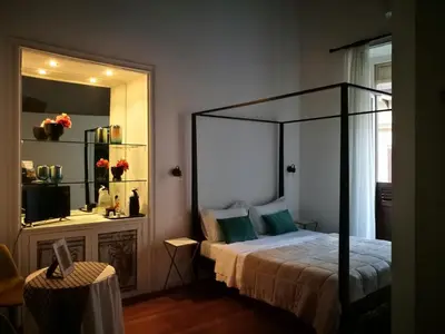 a bedroom with a canopy bed and a mirror at Il Rosone Luxury B&B in Palermo