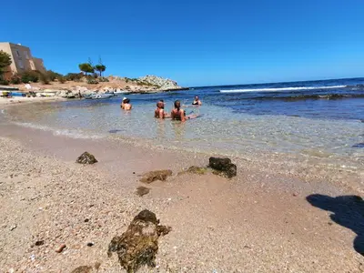a group of people in the water at the beach at B&B Donna Sabella in Santa Flavia