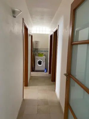 a hallway leading to a laundry room with a washing machine at Appartamento casa mare in Alcamo Marina