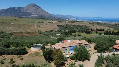 an aerial view of a house with a mountain in the background at Terre Di Himera in Buonfornello