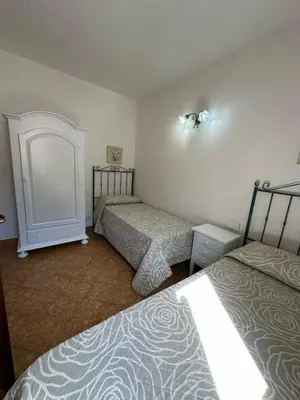a room with two beds in a room at Appartamenti Irene in Macari