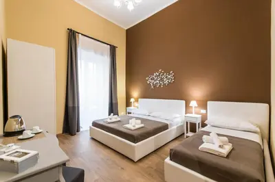 a bedroom with two beds and a chandelier at SheralKes Bed&Breakfast in Palermo