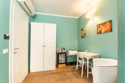 a room with a table and a blue wall at SheralKes Bed&Breakfast in Palermo
