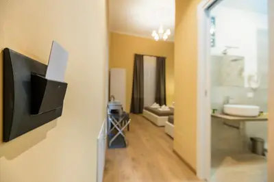 a bathroom with a television on a wall at SheralKes Bed&Breakfast in Palermo