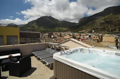 a hot tub on the roof of a building at Sciabika Home - Edificio Egadi in Castellammare del Golfo