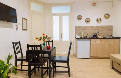 a kitchen with a table and chairs in a room at Il Tempo Ritrovato - Locazione ad uso turistico in Palermo