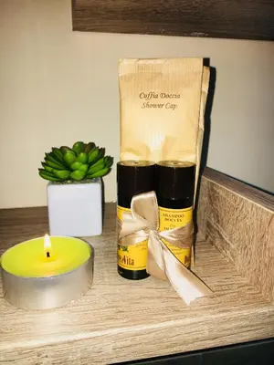 a candle and a bottle of oil on a table at Il Tempo Ritrovato - Locazione ad uso turistico in Palermo