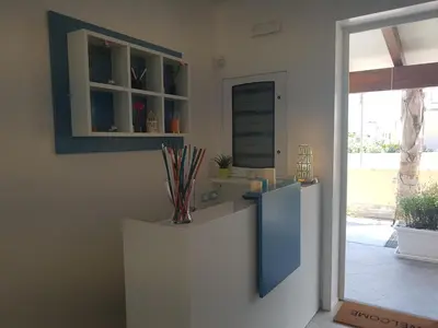 a kitchen with a blue refrigerator and a window at B&B Aloe Comfort Rooms in San Vito lo Capo