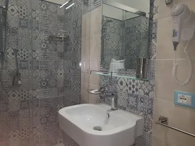 a bathroom with a sink and a shower at B&B Aloe Comfort Rooms in San Vito lo Capo