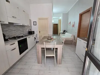 a kitchen with a table and chairs in a room at casa francesca in Castellammare del Golfo