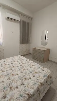 a bedroom with a bed and a dresser and a mirror at casa francesca in Castellammare del Golfo