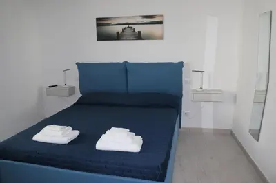 a blue bed with two white towels on it at Le Torri dell'acqua in Palermo