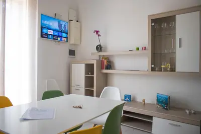 a room with a table and chairs and a tv at Le Torri dell'acqua in Palermo