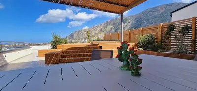 a patio with chairs and a cactus on a deck at Saracen Sands Hotel & Congress Centre - Palermo in Isola delle Femmine