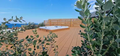 a deck with a hot tub on top of a house at Saracen Sands Hotel & Congress Centre - Palermo in Isola delle Femmine