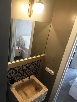 a bathroom with a sink and a mirror at Kurò in Palermo