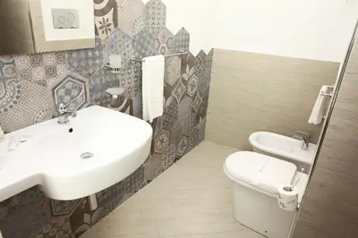 a bathroom with a sink and a toilet at La Nicchia Smart in San Vito lo Capo