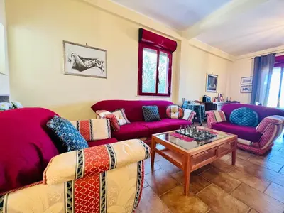 a living room with purple couches and a coffee table at Villa Giada in Carini