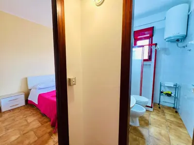 a bathroom with a bed and a toilet in a room at Villa Giada in Carini