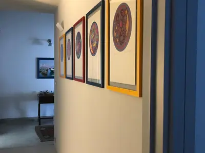 a hallway with a bunch of pictures on a wall at B&B Questa casa non e'un albergo in Palermo