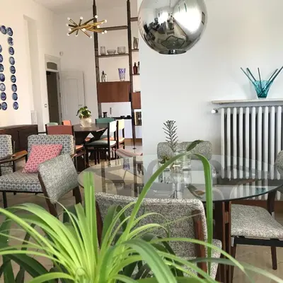 a dining room with a glass table and chairs at B&B Questa casa non e'un albergo in Palermo