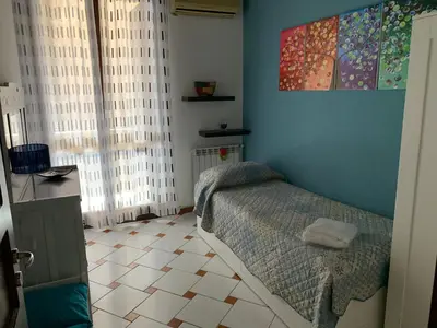 a bedroom with a bed and a tiled floor at Casa nel Vicolo in Palermo