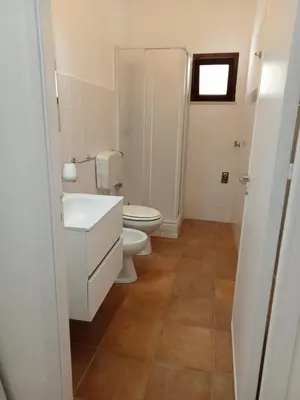 a bathroom with a toilet and a sink at Scopelos in Scopello