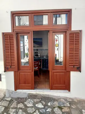 an entrance to a building with a wooden door at Scopelos in Scopello