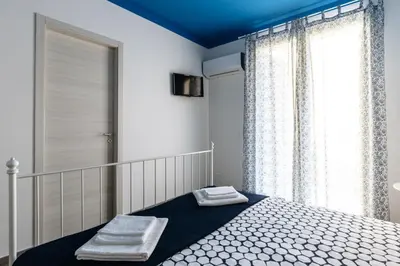 a bedroom with a bed with two towels on it at B&B Medusa in Santa Flavia