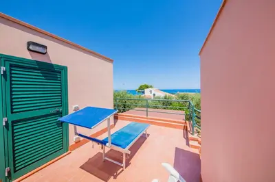 a blue table on the balcony of a house at Villa Bruna in Cefalù