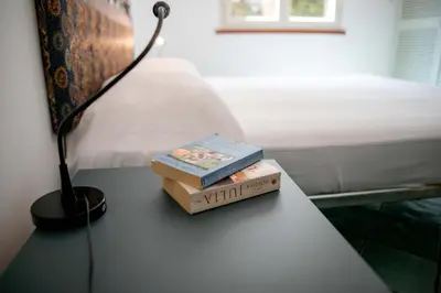 two books sitting on a table next to a bed at Villa Bruna in Cefalù