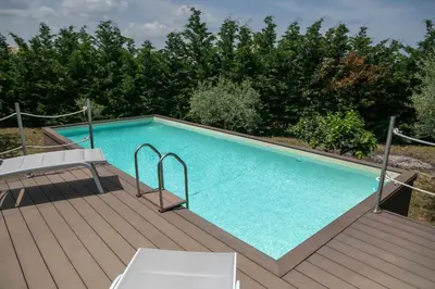 a large swimming pool on a wooden deck at Villa Bruna in Cefalù