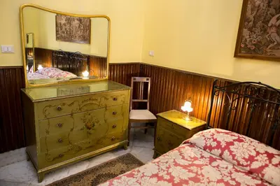 a bedroom with a dresser with a mirror on it at B&B Santa Caterina in Palermo