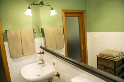 a bathroom with a sink and a mirror at B&B Santa Caterina in Palermo