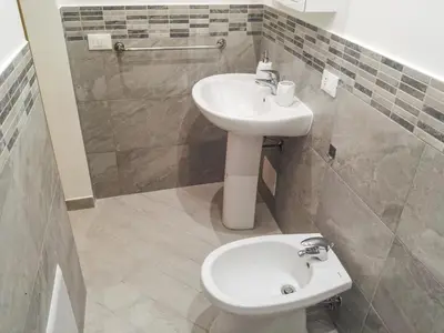 a bathroom with a white sink and a toilet at Madinah apartments in Palermo